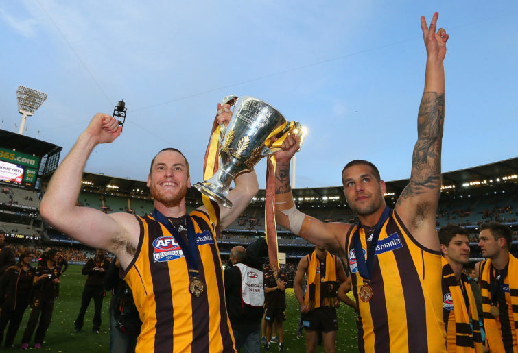Jarryd Roughead and Lance Franklin of the Hawks celebrates with the Premiership Cup after the hawks won the 2013 AFL Grand Final match between the Hawthorn Hawks and the Fremantle Dockers at Melbourne Cricket Ground on September 28, 2013 in Melbourne, Australia.