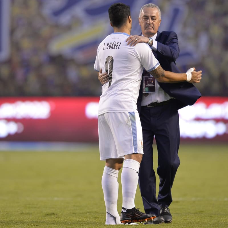Luis Suarez of Uruguay greets Gustavo Alfaro head coach of Ecuado